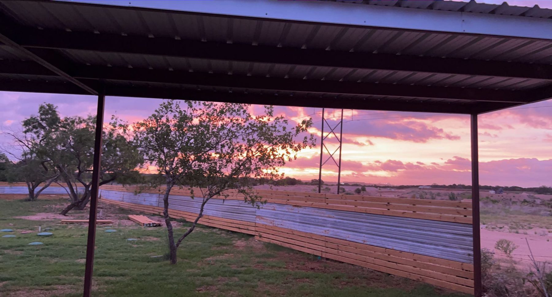 Evening sky over the covered pavilion and open grounds at Z-Ranch RV in Marble Falls, Texas